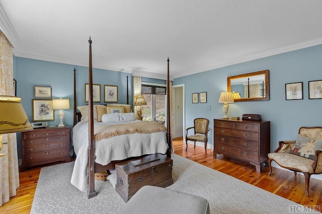 bedroom featuring crown molding and light hardwood / wood-style flooring