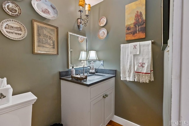 bathroom featuring toilet and vanity