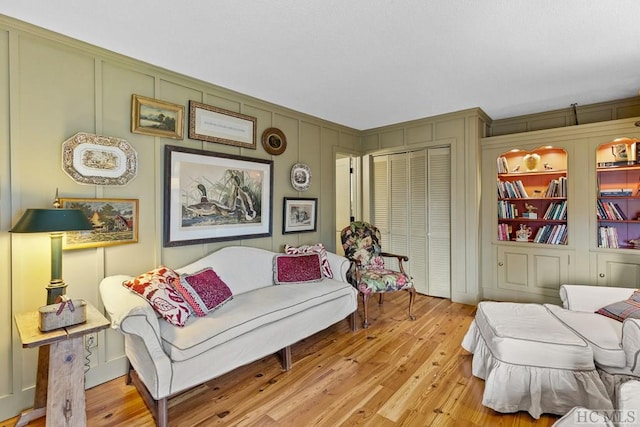 living room with light hardwood / wood-style floors and built in features