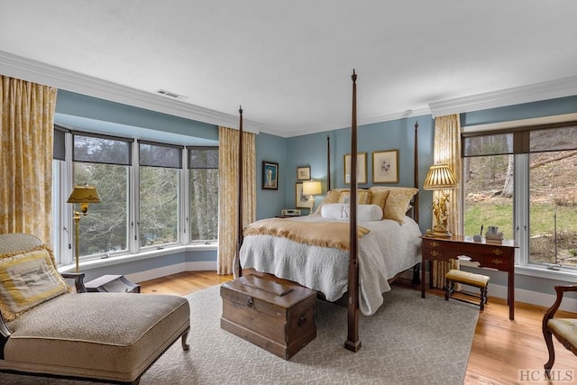 bedroom featuring light wood-type flooring and ornamental molding