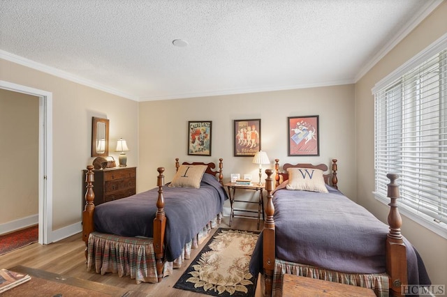 bedroom featuring crown molding, a textured ceiling, and light hardwood / wood-style flooring