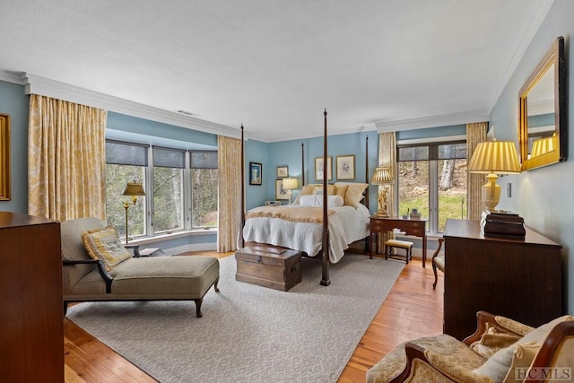 bedroom with crown molding and light hardwood / wood-style floors