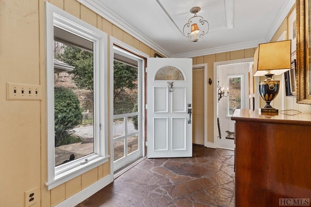 entryway with plenty of natural light and crown molding