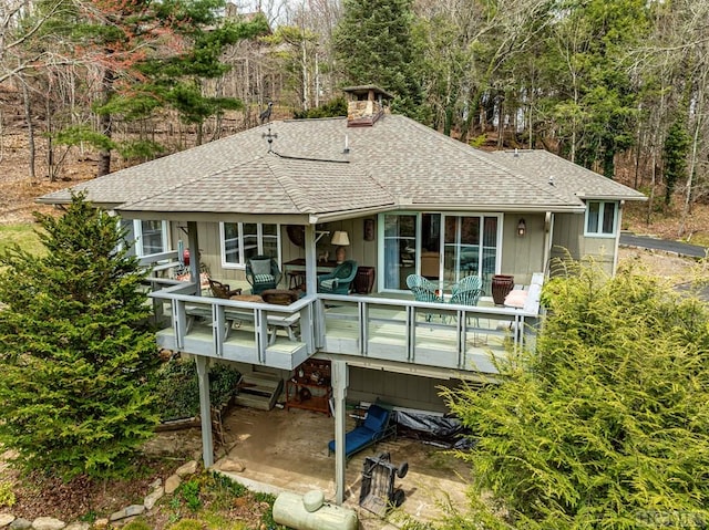 back of house featuring a deck