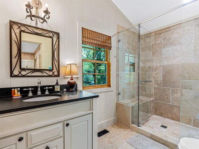 145 Island Point Rd, Lake Toxaway, NC 28747 - bathroom featuring a stall shower, lofted ceiling, vanity, and toilet