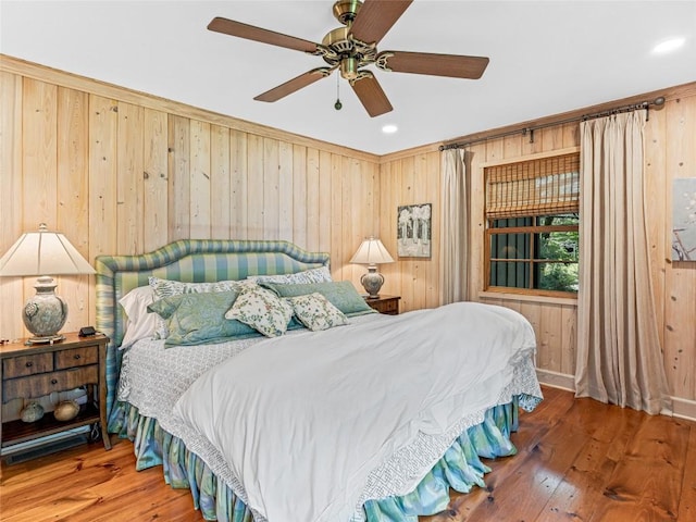 145 Island Point Rd, Lake Toxaway, NC 28747 - bedroom with wood walls, hardwood / wood-style flooring, a ceiling fan, and recessed lighting
