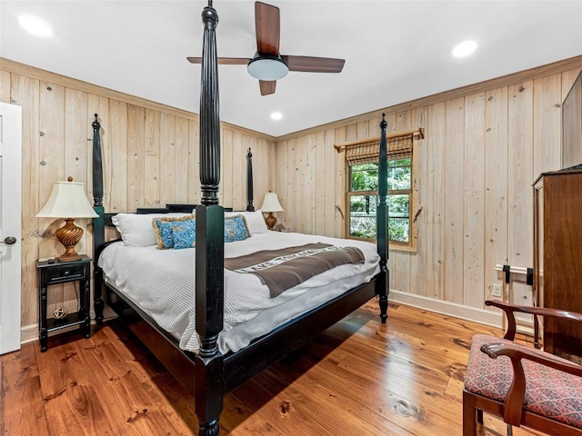 145 Island Point Rd, Lake Toxaway, NC 28747 - bedroom with baseboards, wooden walls, hardwood / wood-style flooring, recessed lighting, and ceiling fan