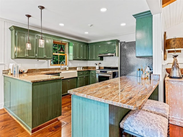 145 Island Point Rd, Lake Toxaway, NC 28747 - kitchen with green cabinetry, stainless steel range with gas stovetop, a peninsula, and recessed lighting