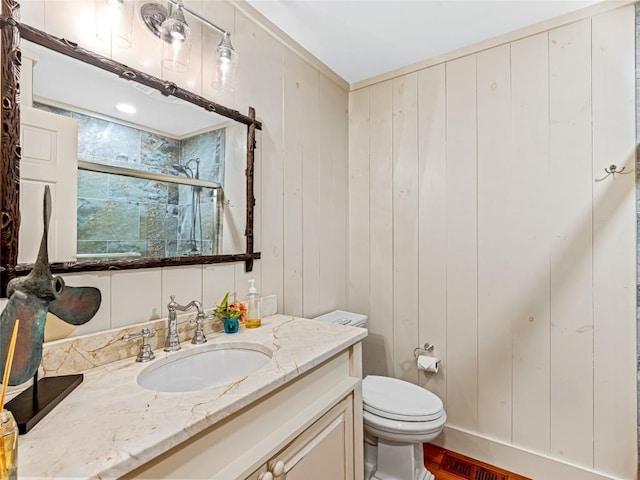 145 Island Point Rd, Lake Toxaway, NC 28747 - bathroom with a shower stall, toilet, vanity, and wood walls