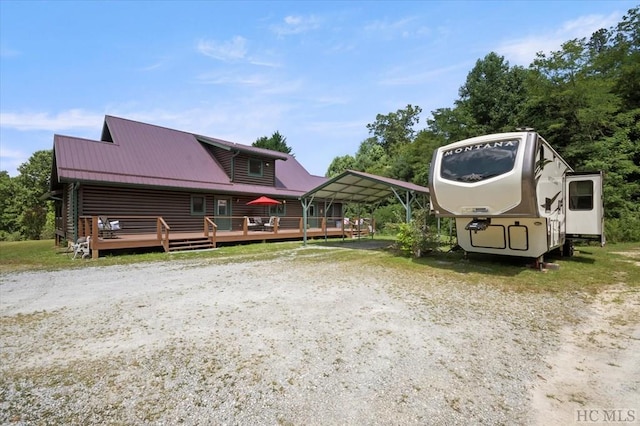 exterior space featuring a carport and a deck