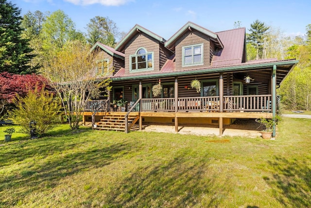 log home featuring a front lawn, covered porch, log exterior, and metal roof