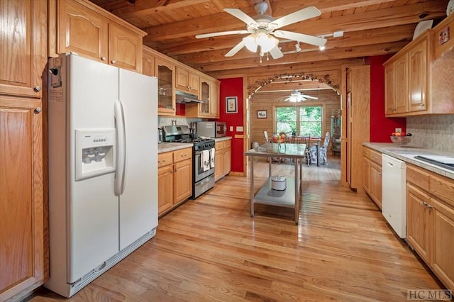 kitchen with light hardwood / wood-style flooring, wooden ceiling, appliances with stainless steel finishes, beamed ceiling, and backsplash