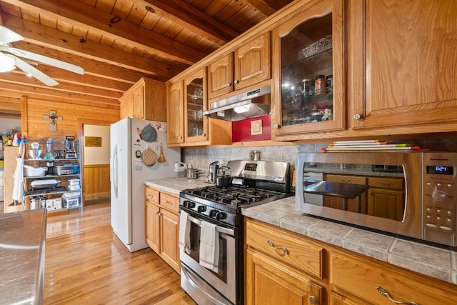kitchen featuring wood ceiling, ceiling fan, appliances with stainless steel finishes, beamed ceiling, and under cabinet range hood