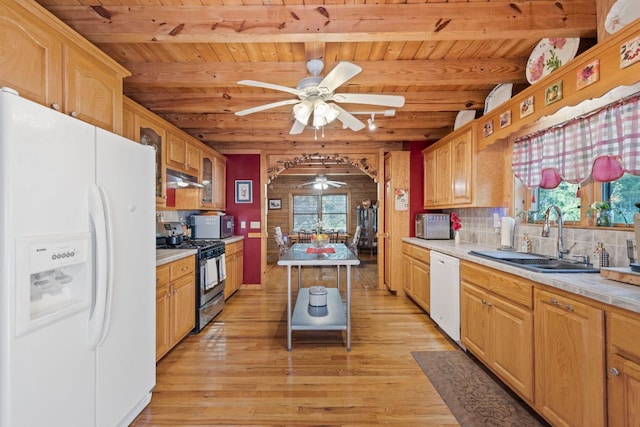 kitchen with a ceiling fan, beamed ceiling, wood ceiling, a sink, and stainless steel appliances
