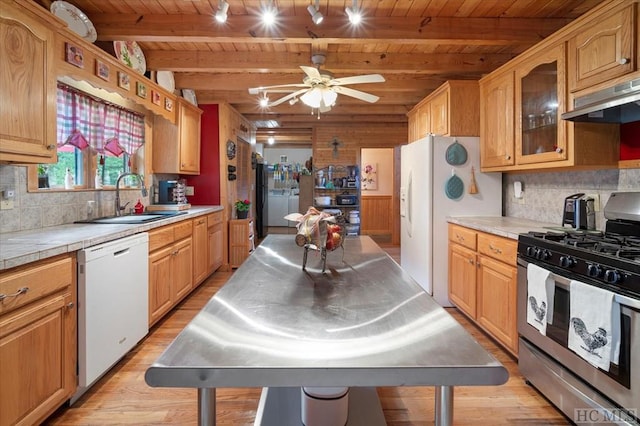 kitchen with sink, light wood-type flooring, wooden ceiling, beamed ceiling, and white appliances