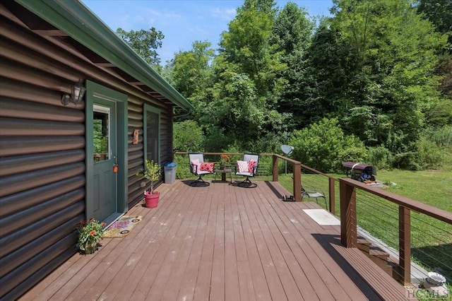 wooden terrace featuring a yard