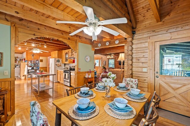 dining room with wooden ceiling, ceiling fan, beamed ceiling, and light wood finished floors