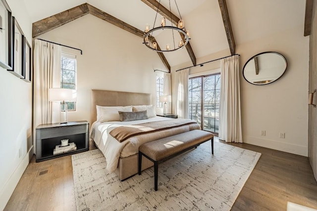 bedroom with visible vents, baseboards, wood finished floors, an inviting chandelier, and beam ceiling