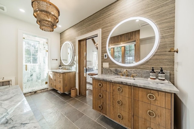 bathroom with plenty of natural light, two vanities, a sink, and backsplash