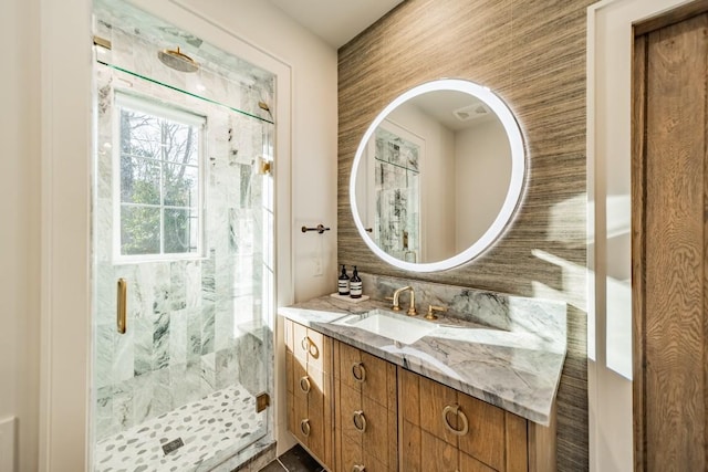 bathroom with a stall shower and vanity