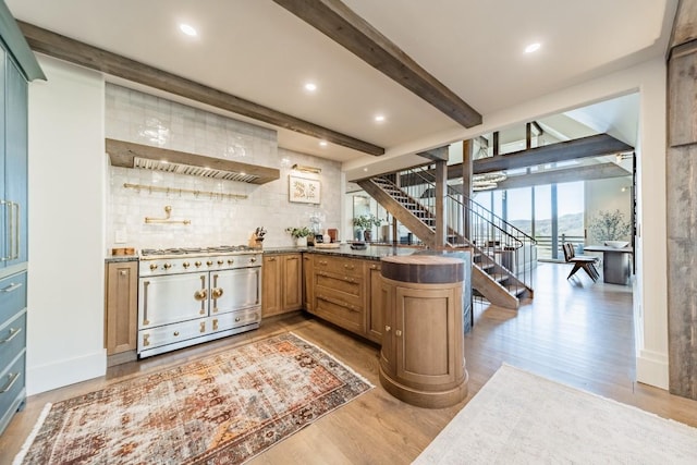 bar with beam ceiling, light wood-style flooring, decorative backsplash, double oven range, and stairs