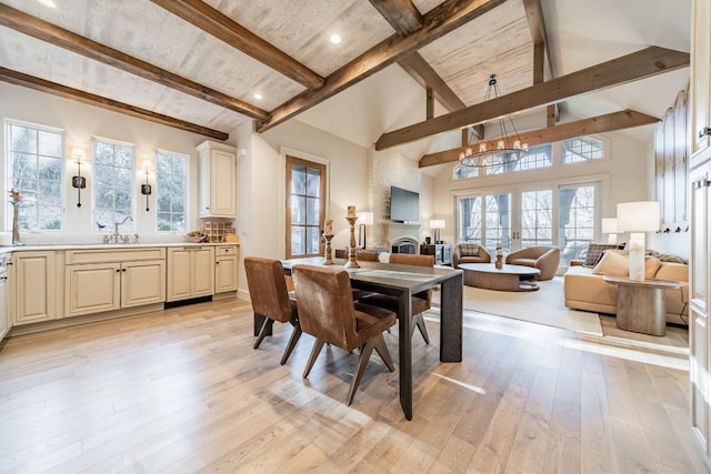 dining space with high vaulted ceiling, french doors, beamed ceiling, and light wood-type flooring