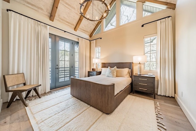 bedroom featuring baseboards, beamed ceiling, access to exterior, light wood-type flooring, and high vaulted ceiling