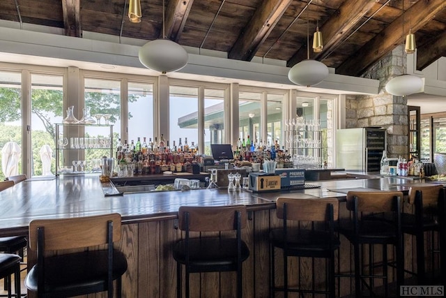 bar with wood ceiling, beamed ceiling, and a bar