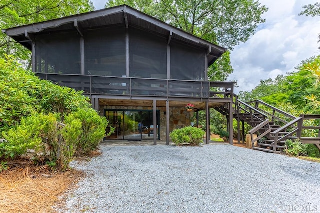 view of car parking with stairway and a carport