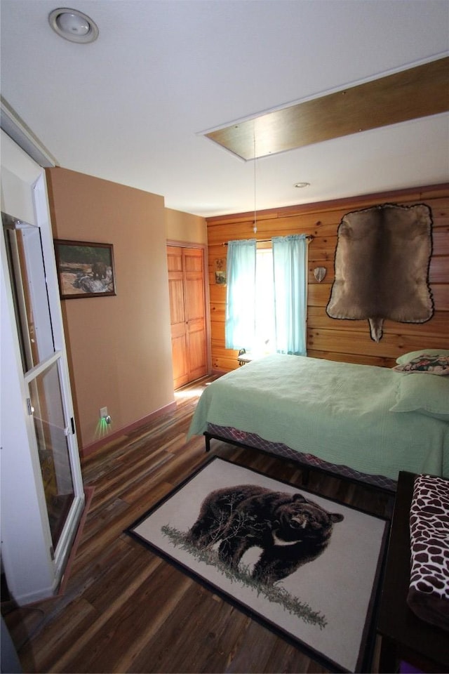 bedroom with attic access and wood finished floors