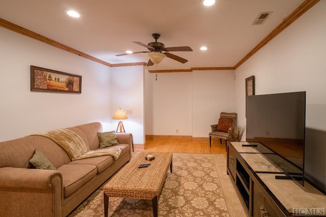 living room with ceiling fan, ornamental molding, and light hardwood / wood-style floors