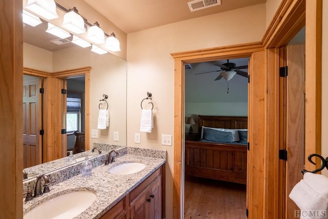 bathroom featuring ceiling fan, vanity, and hardwood / wood-style floors