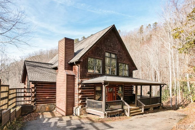 rear view of property with a porch