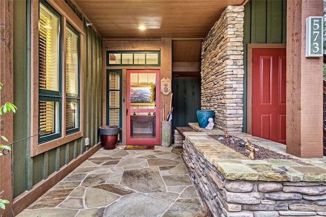 entrance to property featuring stone siding