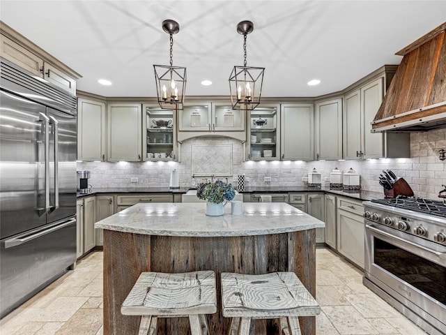64 Toxaway Shrs Unit 2, Lake Toxaway, NC 28747 - kitchen with high quality appliances, custom range hood, stone tile floors, backsplash, and recessed lighting