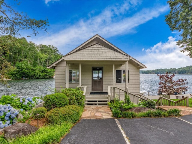 64 Toxaway Shrs Unit 2, Lake Toxaway, NC 28747 - bungalow-style house with a water view, a porch, and uncovered parking