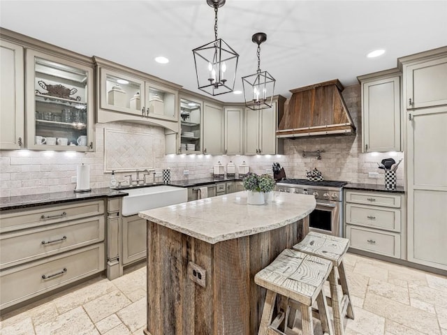 64 Toxaway Shrs Unit 2, Lake Toxaway, NC 28747 - kitchen with premium range hood, high end stainless steel range oven, backsplash, a chandelier, and a breakfast bar
