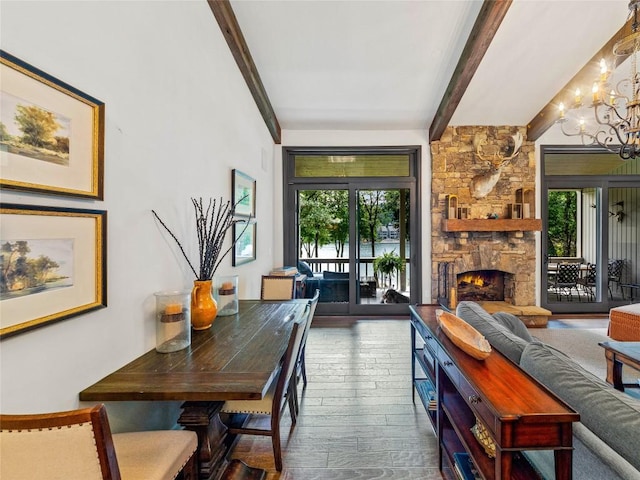64 Toxaway Shrs Unit 2, Lake Toxaway, NC 28747 - dining space with a chandelier, beam ceiling, wood-type flooring, and a stone fireplace