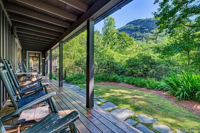 wooden terrace with a mountain view and a porch