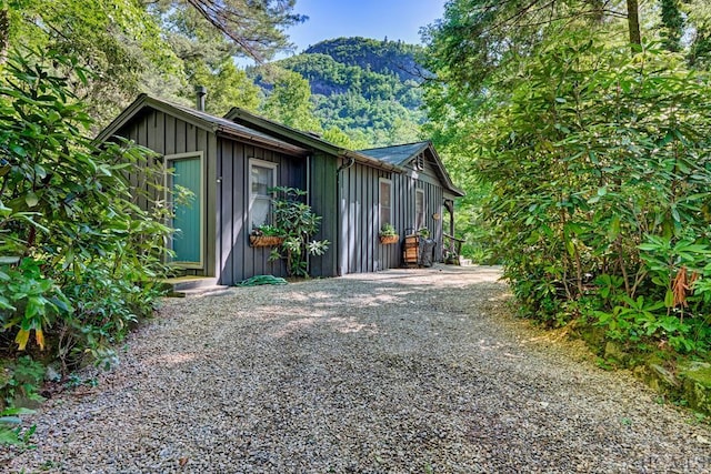 exterior space featuring a mountain view and gravel driveway