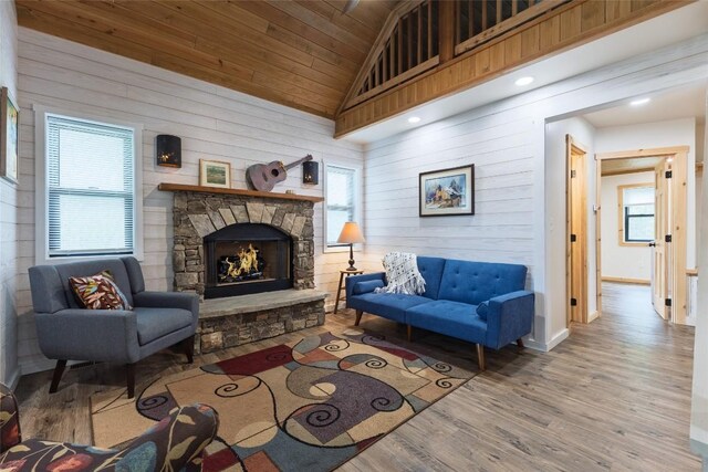 67 Chipmunk Trl, Glenville, NC 28736 - living area featuring healthy amount of natural light, wood walls, wood finished floors, vaulted ceiling, and a fireplace