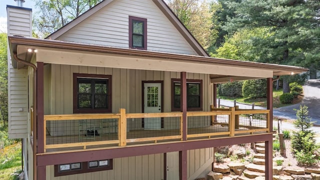 67 Chipmunk Trl, Glenville, NC 28736 - back of house with covered porch and a chimney