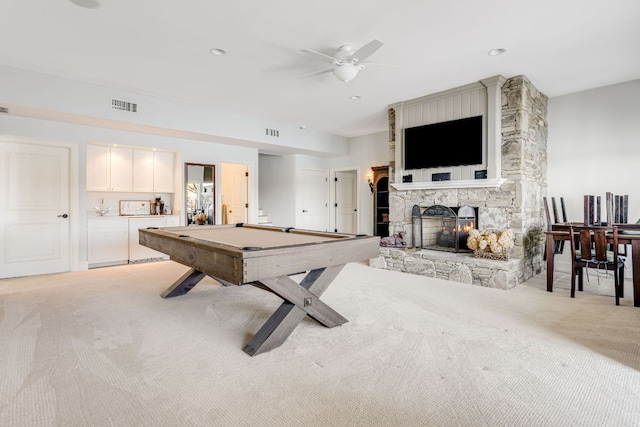 rec room featuring light carpet, billiards, a fireplace, and a ceiling fan