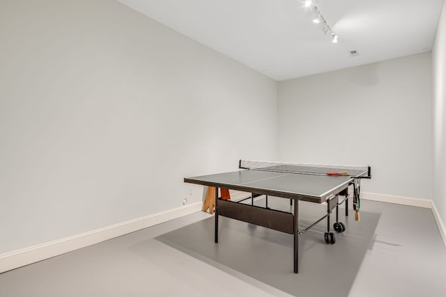 playroom featuring track lighting and baseboards