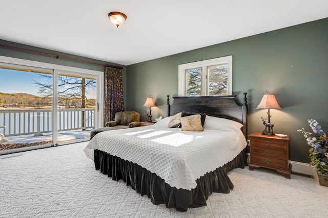 bedroom featuring access to outside, carpet flooring, and multiple windows