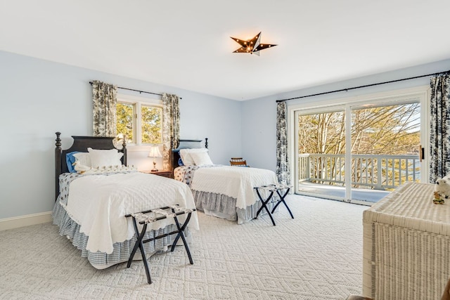 bedroom with access to outside, light carpet, and baseboards