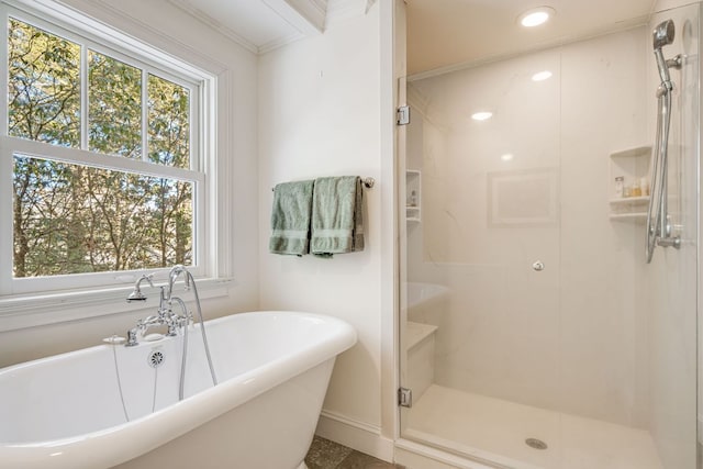 bathroom featuring plenty of natural light, a stall shower, a soaking tub, and recessed lighting