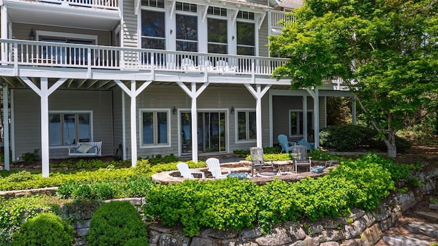 rear view of house featuring an outdoor fire pit