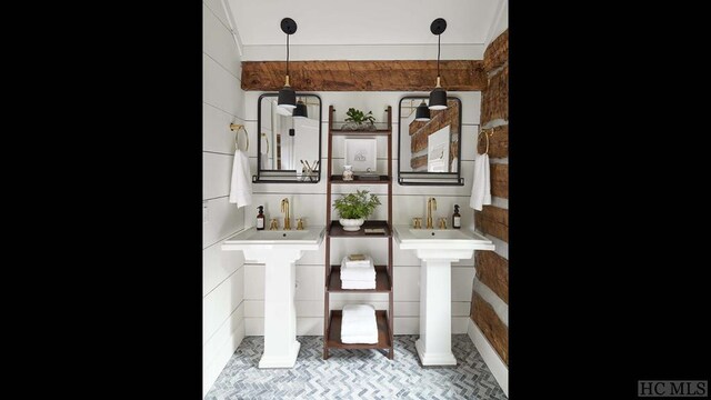 interior space featuring sink, tasteful backsplash, and decorative columns