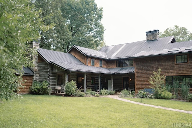 rear view of property featuring a yard